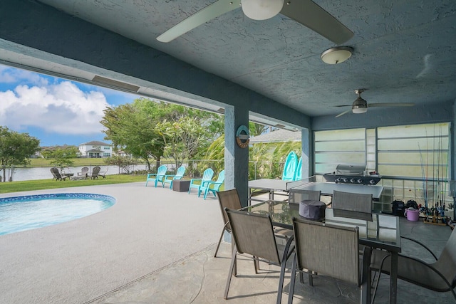 outdoor pool featuring a ceiling fan, outdoor dining area, and a patio area