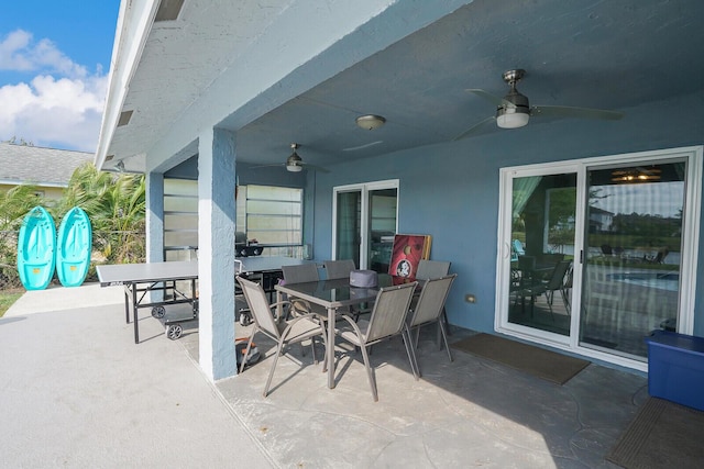 view of patio featuring outdoor dining space and a ceiling fan