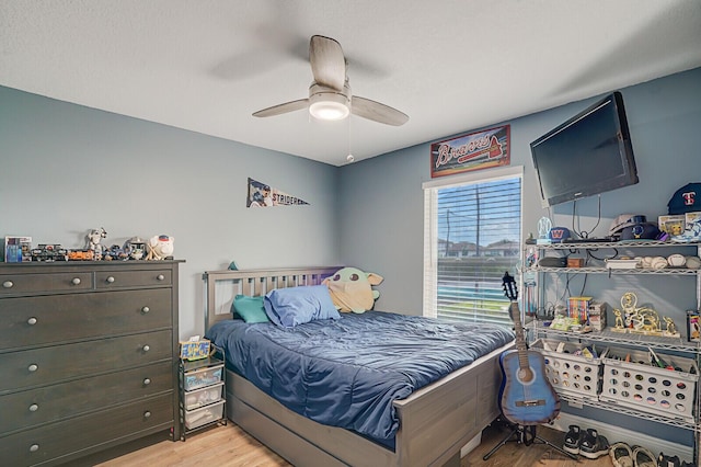 bedroom with light wood-type flooring and ceiling fan