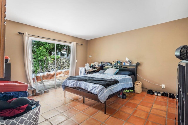 bedroom featuring light tile patterned flooring and access to exterior