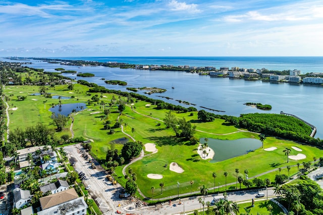 birds eye view of property with a water view and view of golf course