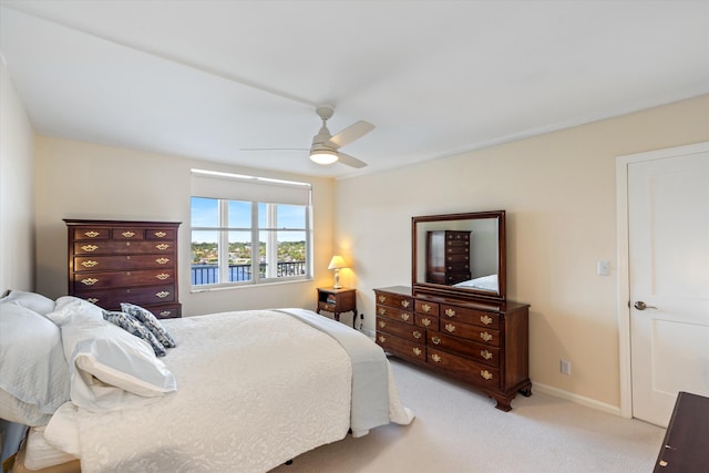 bedroom with light carpet, ceiling fan, and baseboards