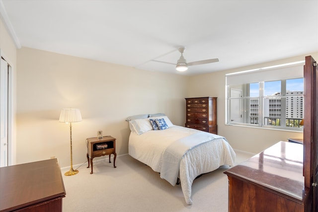 carpeted bedroom featuring ceiling fan and baseboards