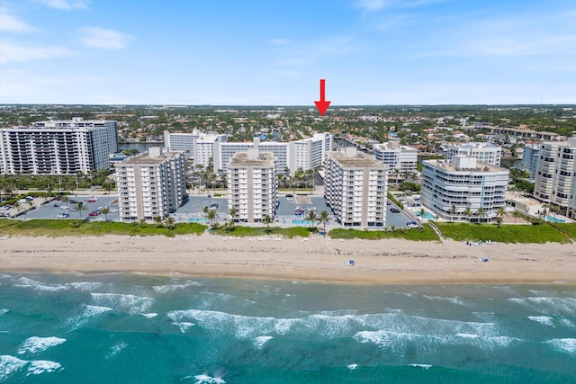 aerial view featuring a water view, a view of city, and a view of the beach