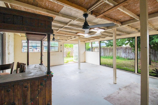 view of patio with ceiling fan and fence