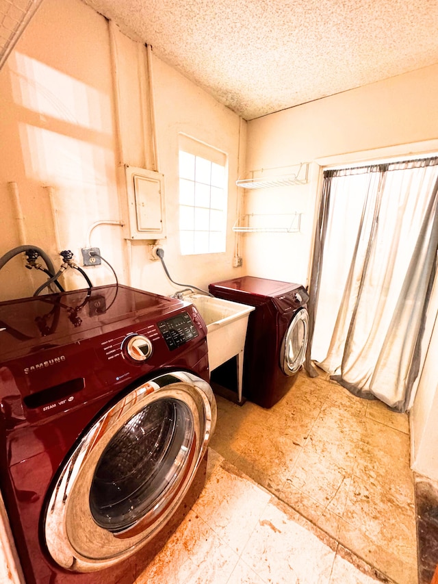 laundry room with laundry area, electric panel, washer / clothes dryer, and a textured ceiling