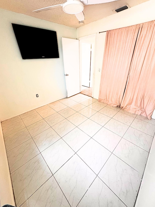 empty room featuring a textured ceiling and visible vents