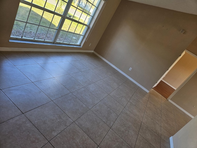 tiled spare room with baseboards