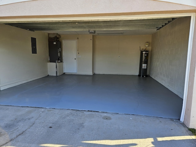 garage featuring heating unit, concrete block wall, electric panel, water heater, and a garage door opener