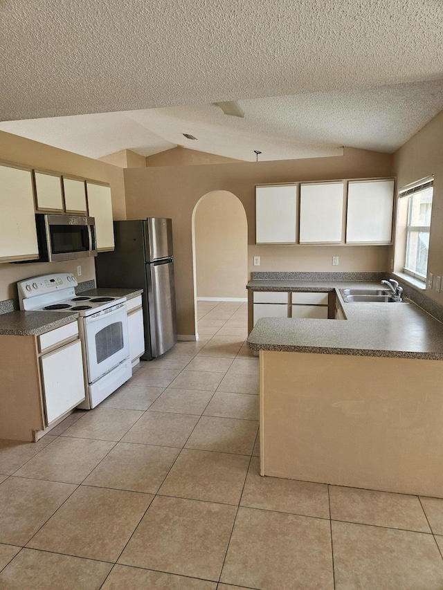 570 Ontario St NW, Palm Bay, FL 32907 - kitchen featuring stainless steel appliances, arched walkways, a textured ceiling, a sink, and light tile patterned flooring