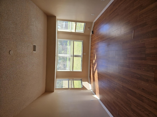 hall featuring wooden walls