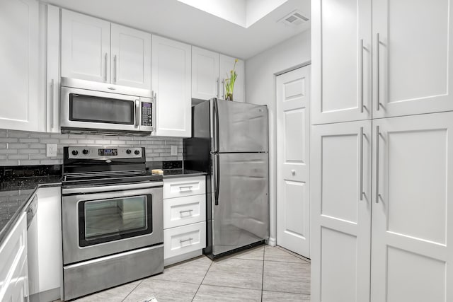 kitchen with tasteful backsplash, visible vents, appliances with stainless steel finishes, and white cabinets