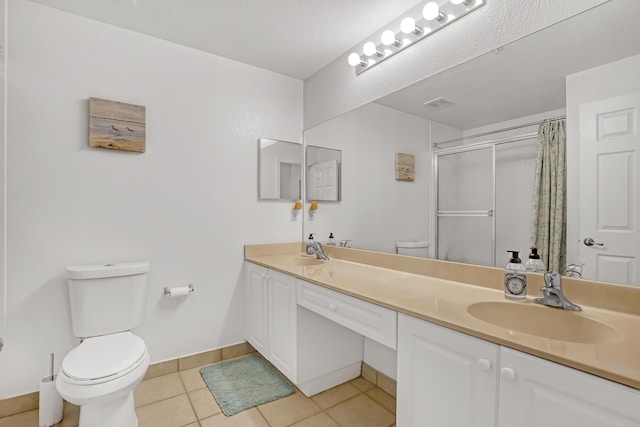 bathroom featuring a shower with shower curtain, a sink, toilet, and tile patterned floors