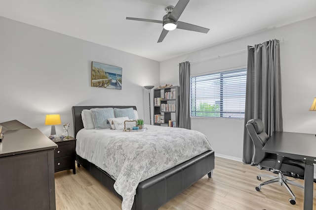 bedroom featuring baseboards, ceiling fan, and light wood finished floors