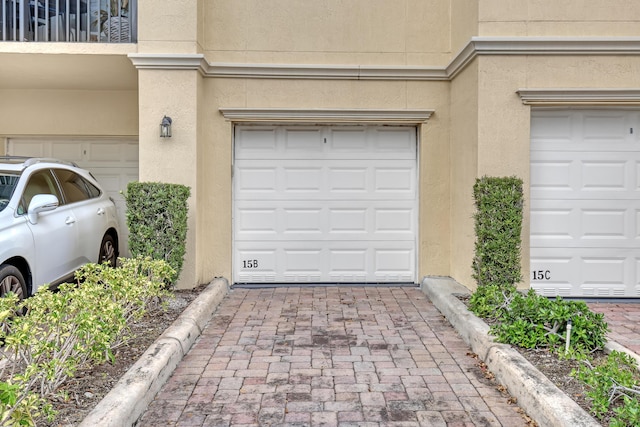 garage featuring decorative driveway