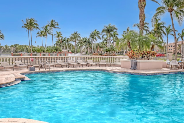 pool featuring a patio and fence