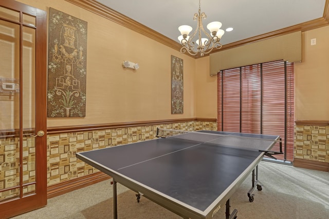 recreation room featuring a wainscoted wall, carpet flooring, and crown molding