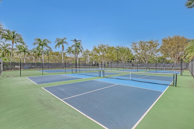 view of tennis court featuring fence