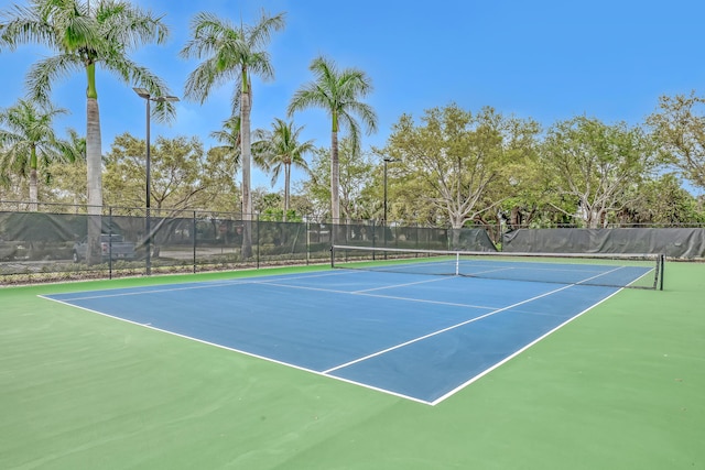 view of sport court featuring fence