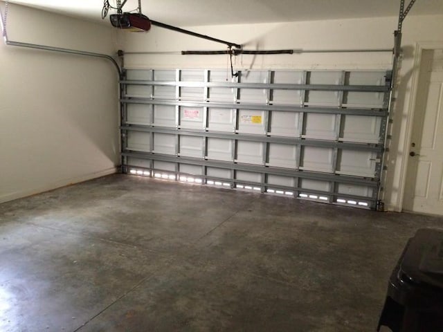 garage featuring baseboards and a garage door opener