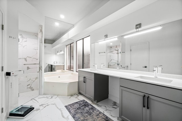 bathroom with double vanity, a marble finish shower, marble finish floor, a garden tub, and a sink