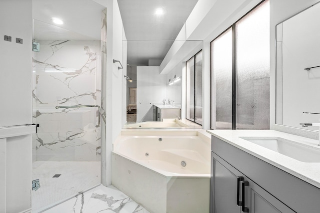 full bath featuring a whirlpool tub, marble finish floor, a marble finish shower, and vanity