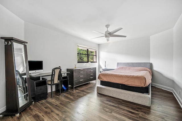 bedroom featuring a ceiling fan, dark wood-style flooring, and baseboards