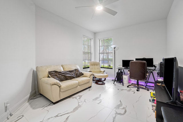 office area featuring marble finish floor, ceiling fan, and baseboards