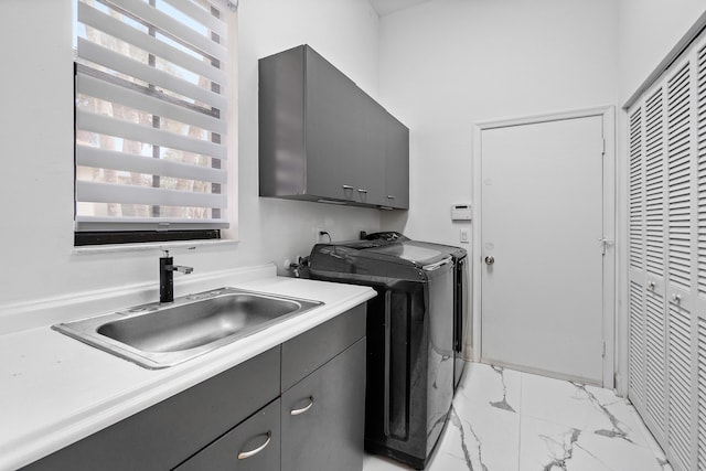 clothes washing area with cabinet space, marble finish floor, separate washer and dryer, and a sink