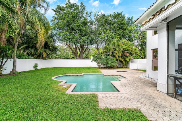 view of swimming pool with a fenced in pool, a yard, a patio area, a fenced backyard, and a jacuzzi