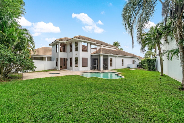 back of property featuring a patio area, a fenced backyard, a tile roof, and a yard