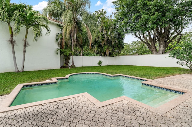 view of pool with a patio area, a fenced backyard, a lawn, and a fenced in pool