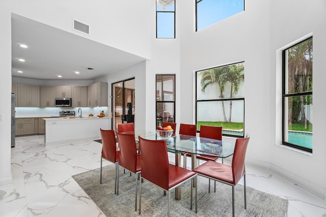 dining space featuring recessed lighting, marble finish floor, visible vents, and plenty of natural light