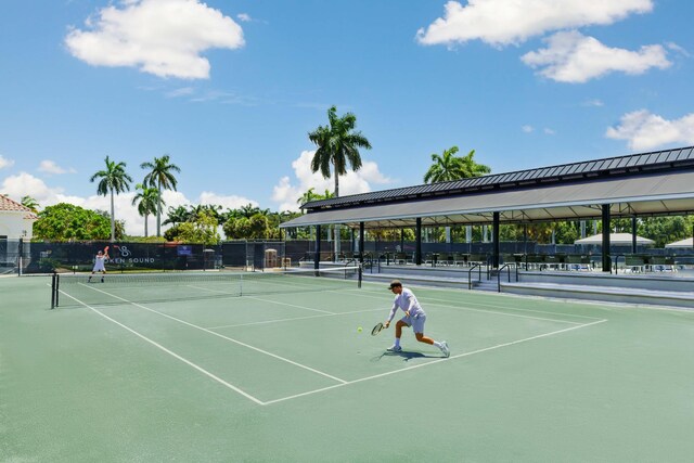 view of sport court featuring fence