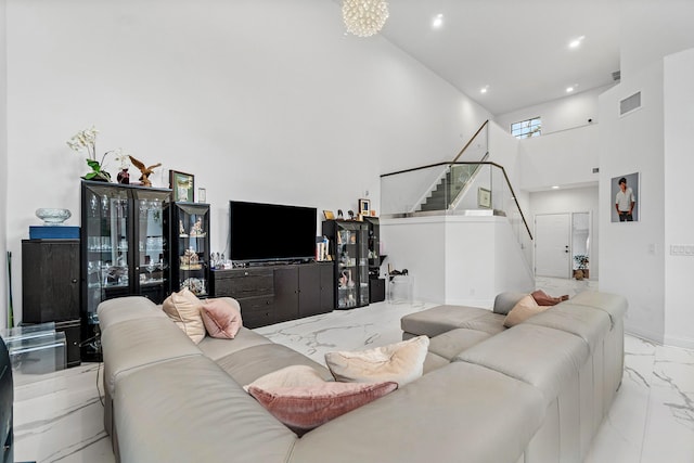 living room with marble finish floor, recessed lighting, visible vents, stairway, and a high ceiling