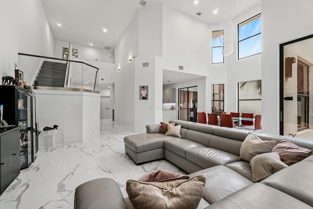 living area featuring marble finish floor, visible vents, and recessed lighting