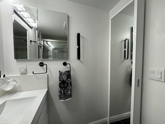 bathroom with a stall shower and vanity