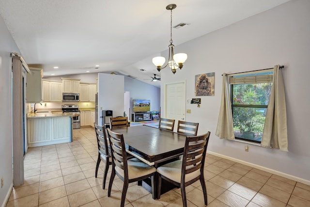 dining area featuring light tile patterned floors, visible vents, vaulted ceiling, and a notable chandelier