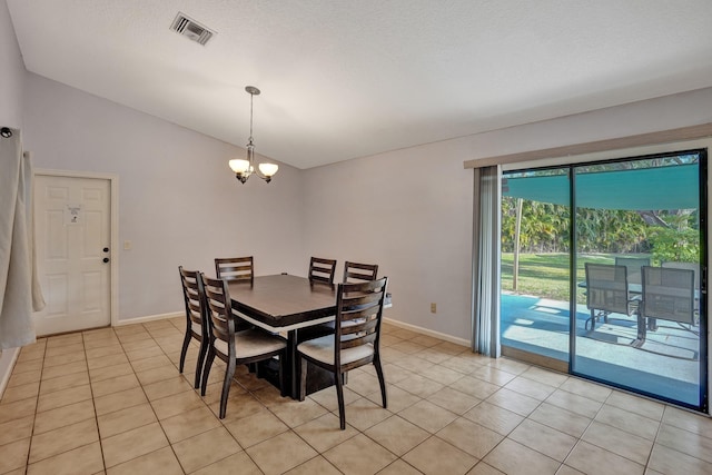 dining space featuring light tile patterned floors, baseboards, visible vents, lofted ceiling, and an inviting chandelier