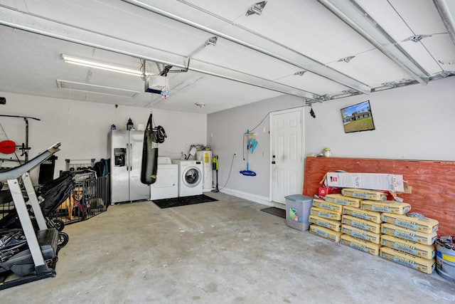 garage with a garage door opener, stainless steel fridge with ice dispenser, and separate washer and dryer