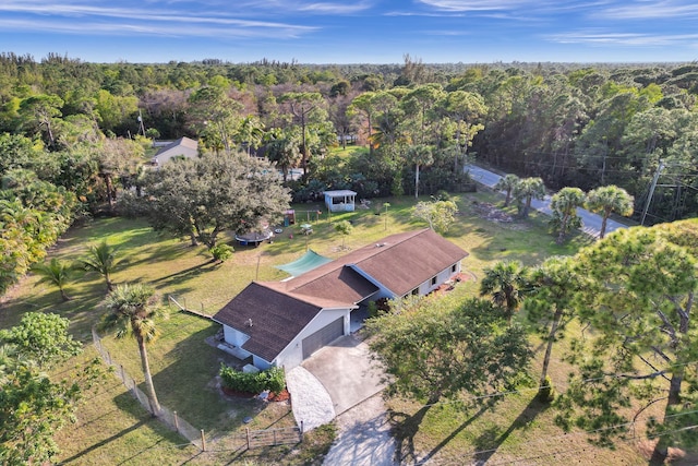 birds eye view of property featuring a view of trees