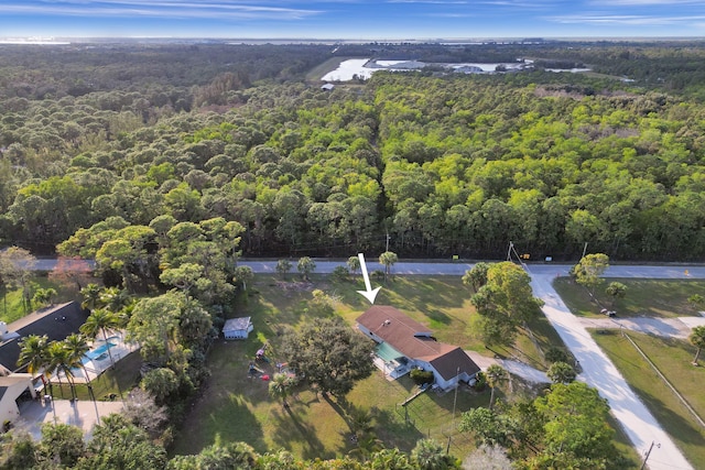 birds eye view of property featuring a forest view