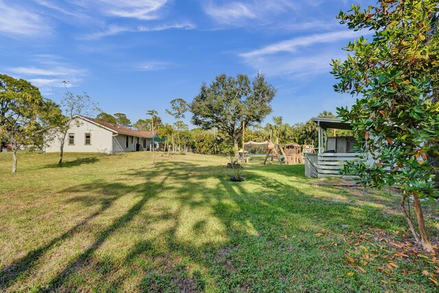 view of yard with a garage and fence