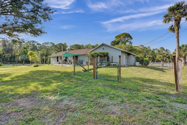 view of yard with fence and a gate