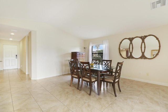 dining space featuring visible vents, vaulted ceiling, baseboards, and light tile patterned floors