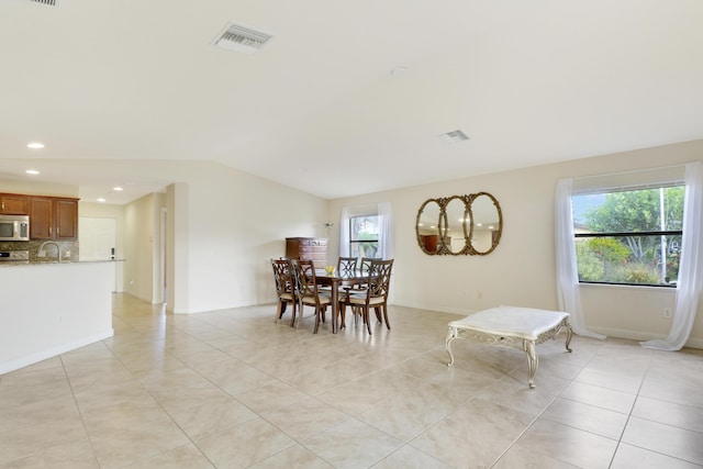 dining room featuring lofted ceiling, light tile patterned floors, recessed lighting, visible vents, and baseboards