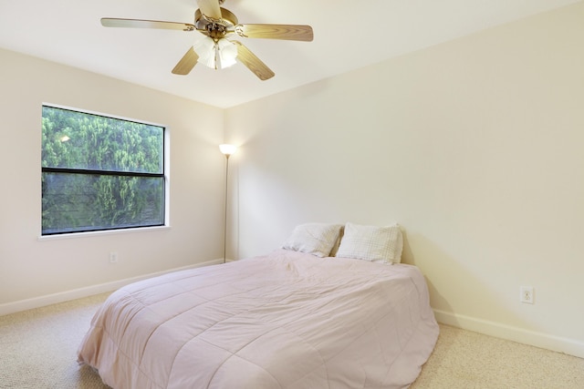 bedroom with carpet, a ceiling fan, and baseboards