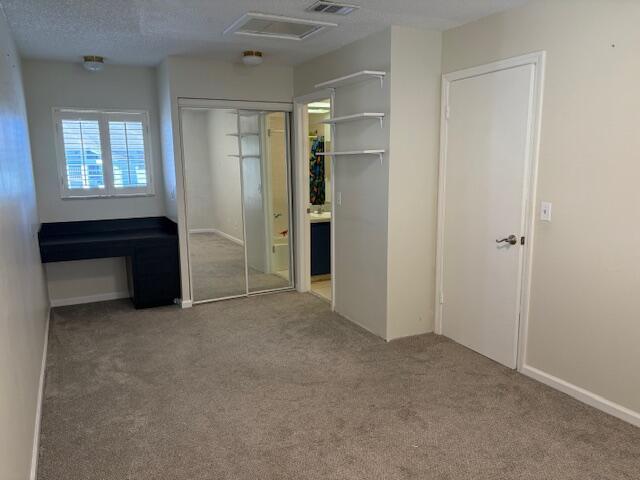 unfurnished bedroom featuring visible vents and carpet flooring