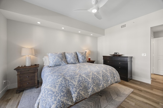 bedroom featuring light wood-type flooring, baseboards, visible vents, and recessed lighting