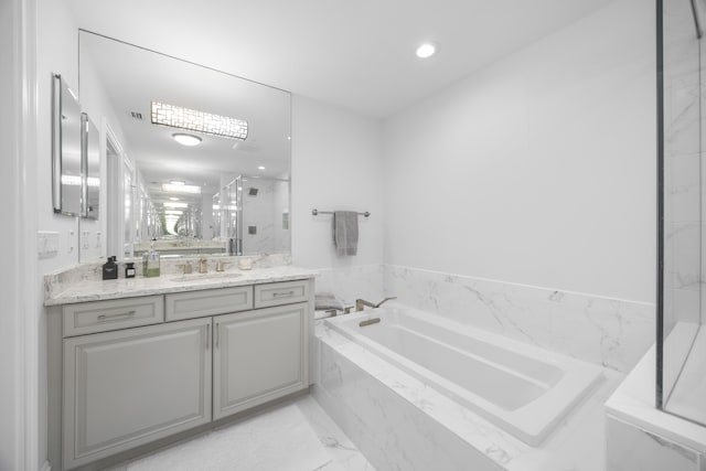 full bath with a bath, a marble finish shower, vanity, and recessed lighting